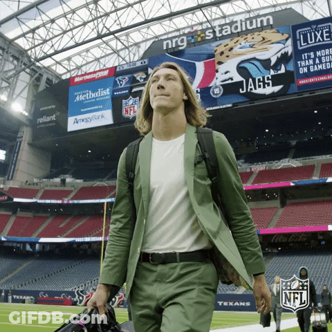 Man In Green Suit Walking Past NFL Sign GIF