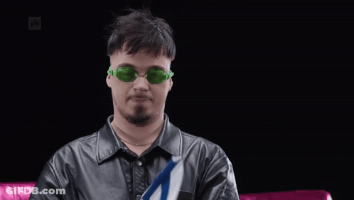 Man In Green Sunglasses Holding Small Flag GIF