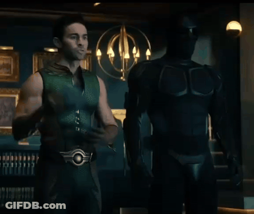 Man In Green Superhero Costume Holding Cell Phone GIF