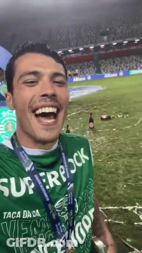 Man In Green Superrock Shirt Smiling GIF