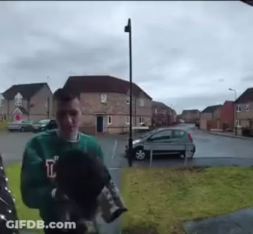 Man In Green Sweater Holding Dog GIF