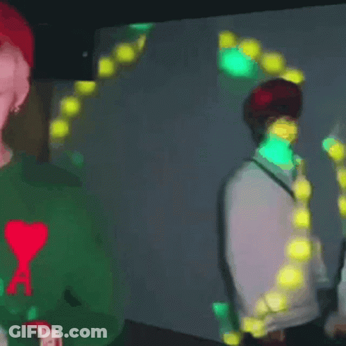 Man In Green Sweater Holding Lit Candle GIF