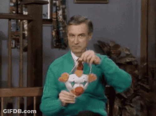 Man In Green Sweater Holding Toy Chicken GIF