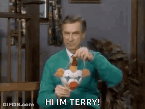 Man In Green Sweater Holding Toy Saying Hi Im Terry GIF