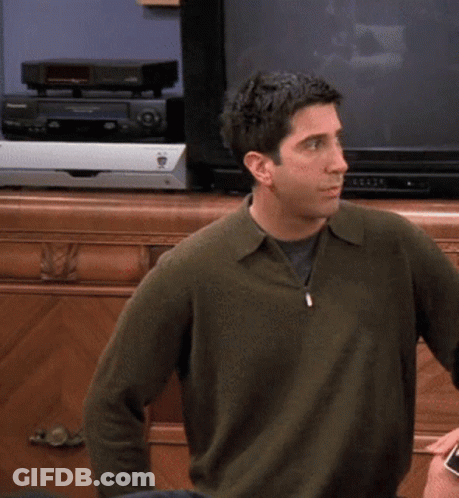 Man In Green Sweater In Front Of Pioneer Video Player GIF