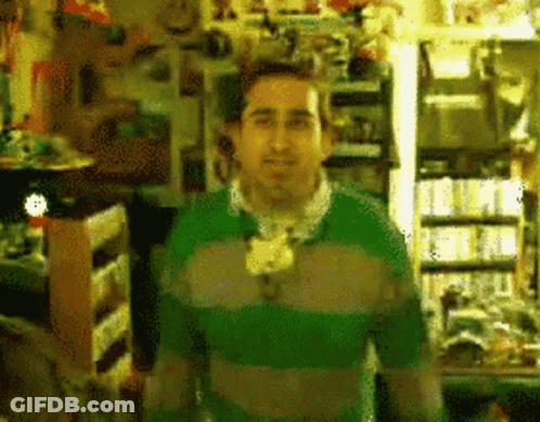 Man In Green Sweater In Store GIF