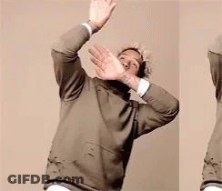 Man In Green Sweater Making Stop Sign GIF