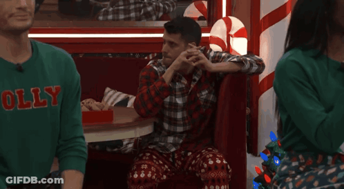 Man In Green Sweater Saying Holly In Booth GIF