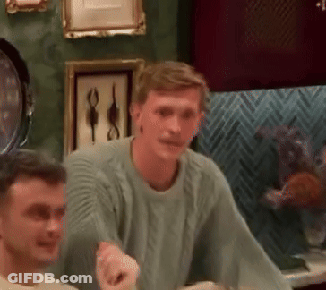 Man In Green Sweater Talking To Another Man GIF