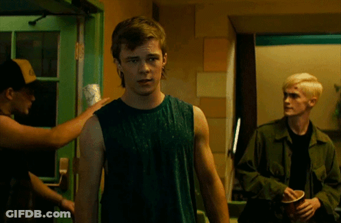 Man In Green Tank Top In Front Of Green Door GIF