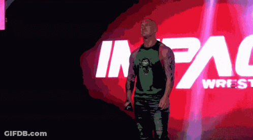 Man In Green Tank Top In Front Of Impact Wrestling Logo GIF