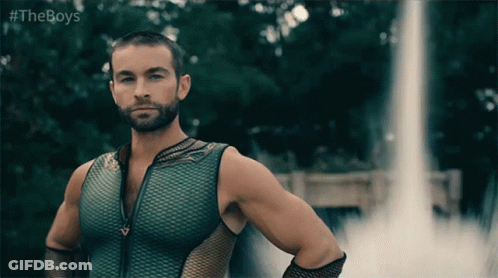 Man In Green Tank Top In Front Of Waterfall GIF