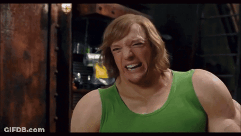 Man In Green Tank Top Making A Face GIF