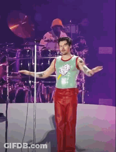 Man In Green Tank Top Red Pants Microphone GIF
