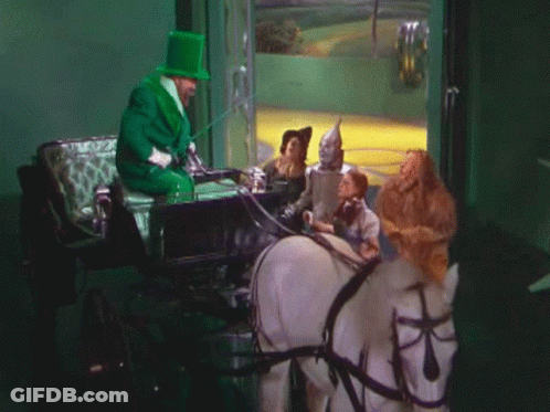 Man In Green Top Hat Pulling Carriage GIF