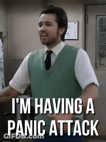 Man In Green Vest And Tie Saying Panic Attack GIF