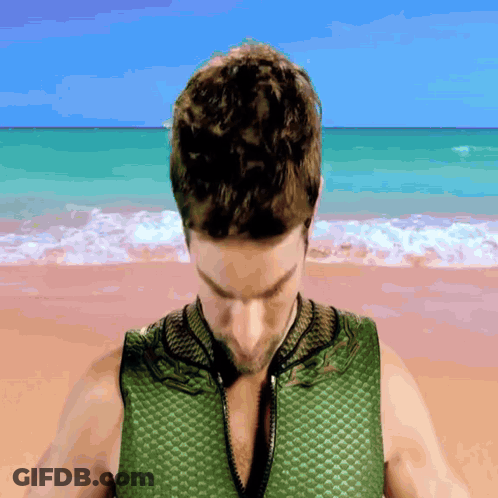 Man In Green Vest On Beach GIF