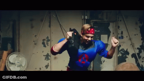 Man In Green Wig And Purple Hat In Front Of Mirror GIF