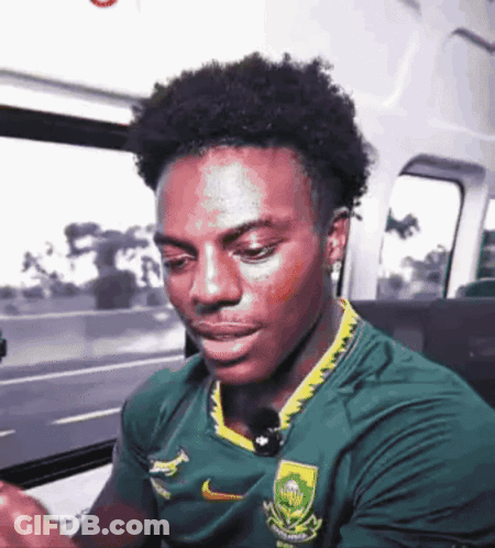 Man In Green Yellow Nike Shirt Looking Down GIF