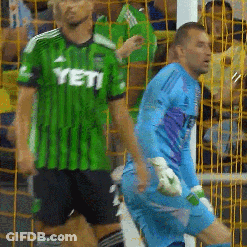 Man In Green Yeti Jersey Next To Man In Blue Jersey GIF