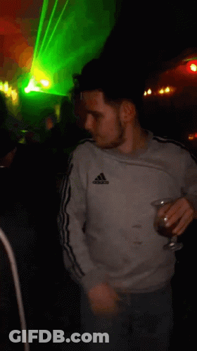 Man In Grey Adidas Sweatshirt Holding Glass GIF