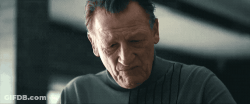 Man In Grey Adidas Sweatshirt Holding Glass GIF
