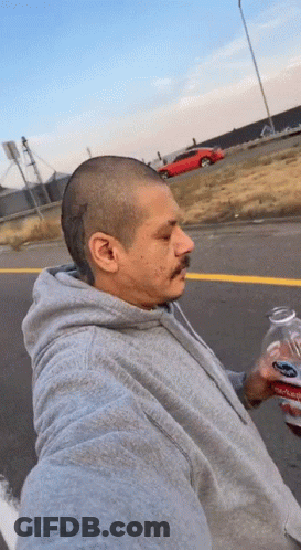 Man In Grey Hoodie Holding Soda GIF
