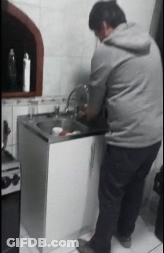 Man In Grey Hoodie Washing Dishes GIF