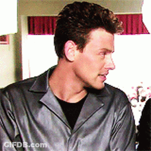 Man In Grey Jacket And Black Shirt Looking Left GIF