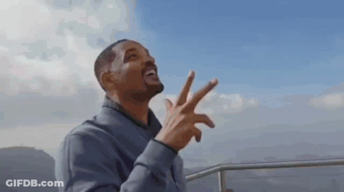 Man In Grey Jacket Giving Peace Sign GIF