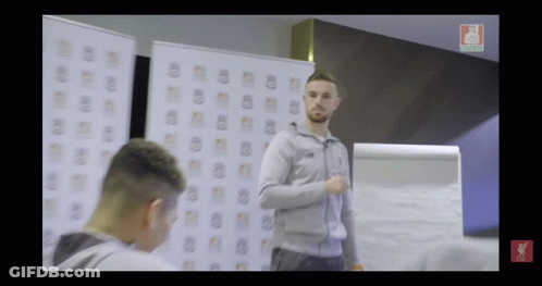 Man In Grey Jacket In Front Of Liverpool Whiteboard GIF