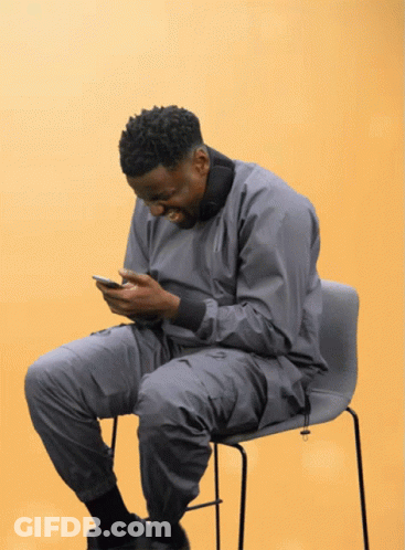 Man In Grey Jacket Looking At Phone GIF