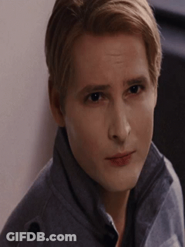 Man In Grey Jacket Looks At Camera GIF