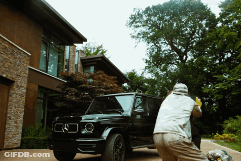 Man In Grey Jacket Standing In Front Of Glass Wall GIF
