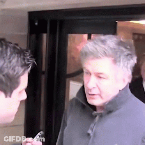 Man In Grey Jacket Talking To Man In Black Jacket GIF