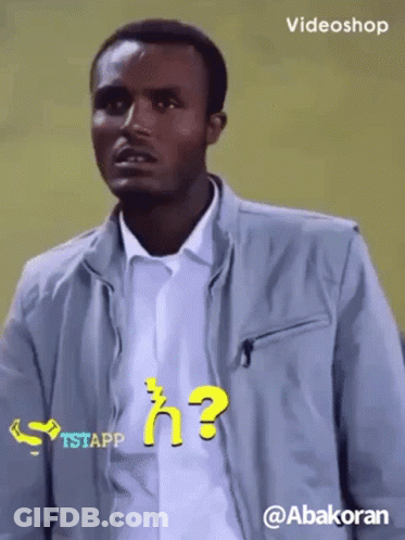 Man In Grey Jacket With Question Mark Shirt GIF
