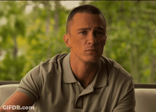 Man In Grey Polo Shirt Sitting On Couch GIF