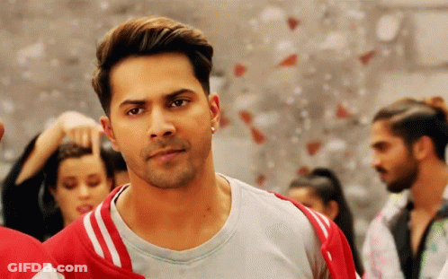 Man In Grey Shirt And Red Jacket In Front Of Group GIF