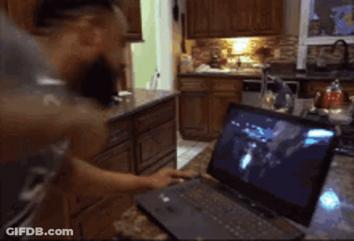 Man In Grey Shirt Cooking In Kitchen GIF