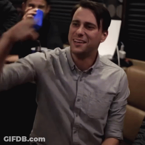 Man In Grey Shirt Holding Blue Can GIF