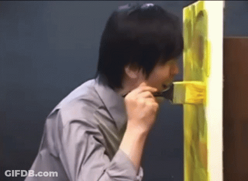 Man In Grey Shirt Holding Brush In Mouth GIF