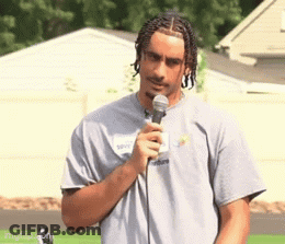 Man In Grey Shirt Holding Microphone GIF