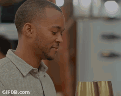 Man In Grey Shirt Holding Wine GIF