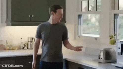 Man In Grey Shirt Next To Toaster And Window GIF