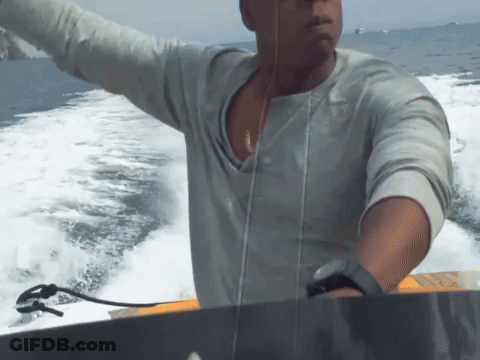Man In Grey Shirt Riding Boat GIF