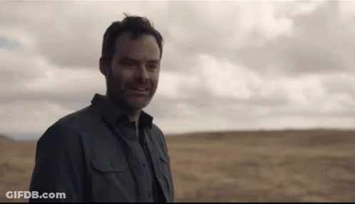 Man In Grey Shirt Standing In Field GIF