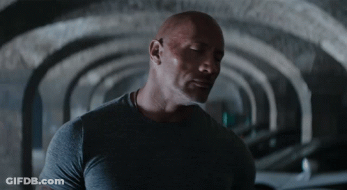 Man In Grey Shirt Standing In Tunnel GIF