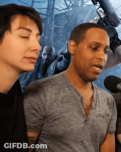 Man In Grey Shirt Talking Into Microphone GIF