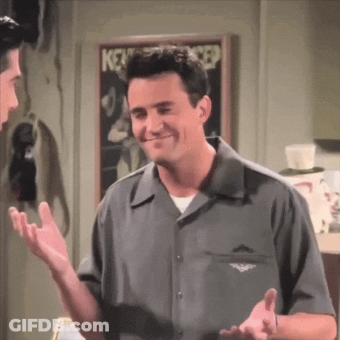 Man In Grey Shirt Talking To Man In Front Of Keystone Cop Poster GIF