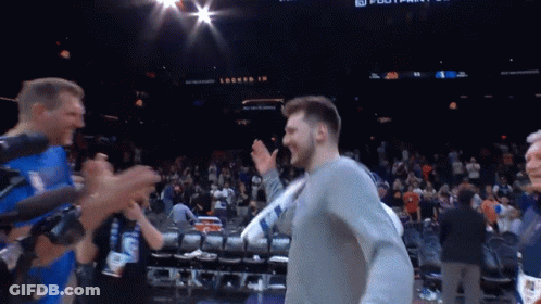Man In Grey Shirt With Locked In Sign In Crowd GIF